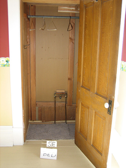 Closet next to blue oval tub